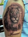 lion head and jesus text tattoo