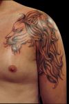 lion head tattoo on left shoulder