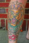 lion head tattoo on leg