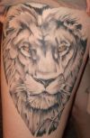 lion head tattoo on thigh