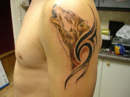 Wolf Head Tribal Tattoo On Left Arm