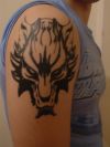 wolf head tattoo on right arm