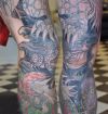 large frog tattoo on leg