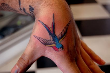 Flying Bird Tattoo On Back Of Palm