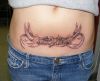 flying bird tattoo on lower stomach