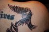 text and flying bird tattoo