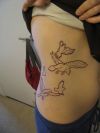 flying birds tattoo on rib