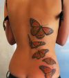 butterfly pic tattoo on back of girl