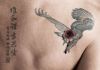 wounded eagle back tattoo