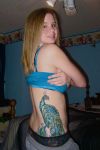 peacock tattoo on side back of girl