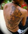 peacock tattoos pics on side back of girl