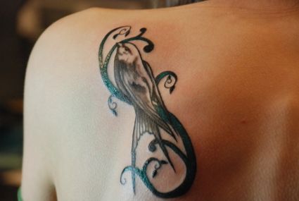 Tribal Bird Pic Tattoo On Left Shoulder Blade