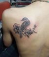 bird and flower pic tattoo on back
