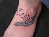 feather and flying bird pic tattoo on feet