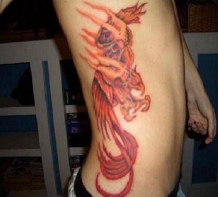 Phoenix Pic Tattoo On Rib Of Guy