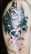joker and cards tattoo on arm
