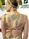 anastacia back,neck and lower back tattoo