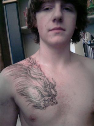 Dragon Pic Tattoo On Chest Of Guy