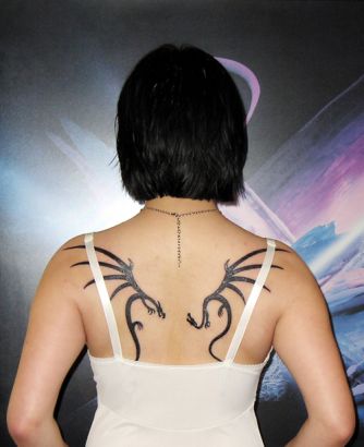Tribal Dragon Pic Tattoo On Back Of Girl