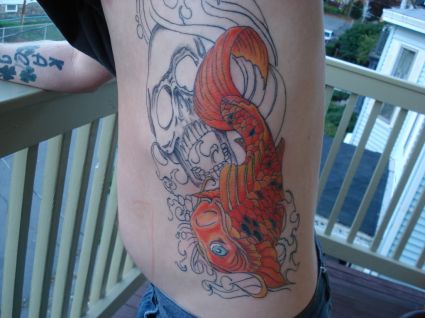 Koi Fish On Rib Tattoo