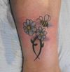 daisy flower and bee tattoos