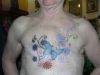 man with daisy flower tat