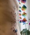dandelion flower tattoo on rib of women