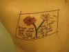 text and dandelion flower tattoo on back