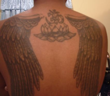 Lotus And Om Tats On Back