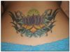 purple lotus tats on lower back