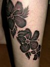 black flower tattoo on leg