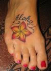 text and flower tattoo