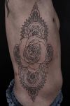 rose tats on rib