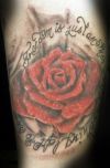 rose and text tats on knee