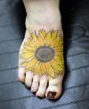 sunflower pic tattoo on feet