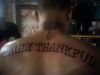 text tattoo on back