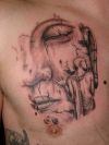 buddha face tattoo on chest