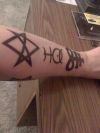religious symbol tattoo on arm