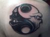 yin yang tattoo on shoulder blade