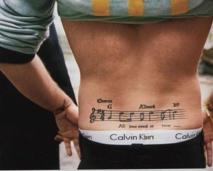 Music Tat On Man's Lower Back