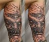 demon face tattoos on leg