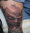 demon tattoo image on leg