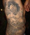 demon tattoo on rib