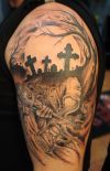 grim reaper and cross tattoo on arm