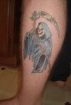 grim reaper tattoo image on leg