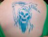 grim reaper tattoo on back of girl