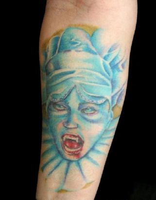 Blue Vampire Face Tattoo On Arm