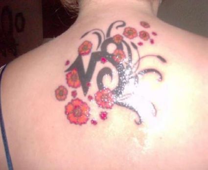 Capricorn Sign And Flower Tattoo On Back