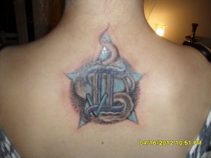 A Zodiac/Initial Coverup Tattoo