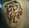 leo pics tattoo on left shoulder blade